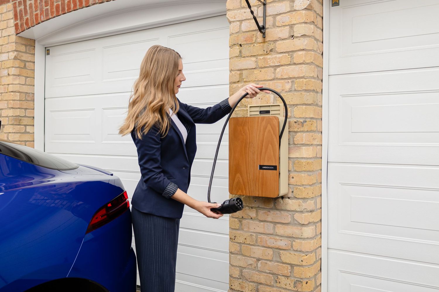 A home EV charge point mounted on a brick pillar