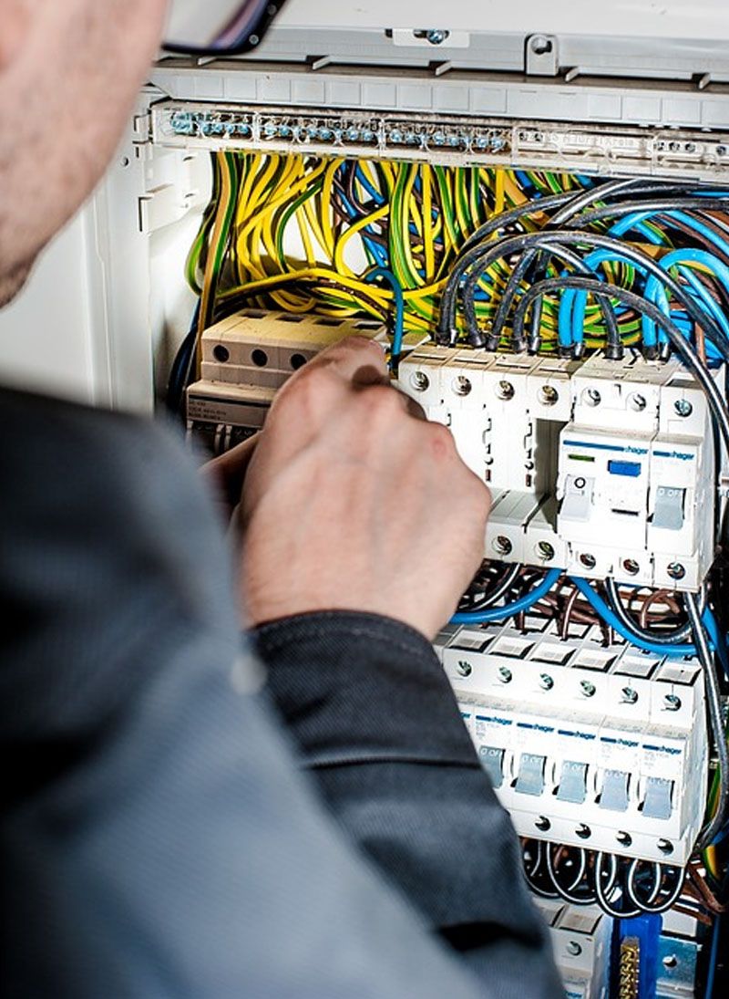 Terminations being made off inside a replacement consumer unit, earths sleeved and dressed so the next person can read it.